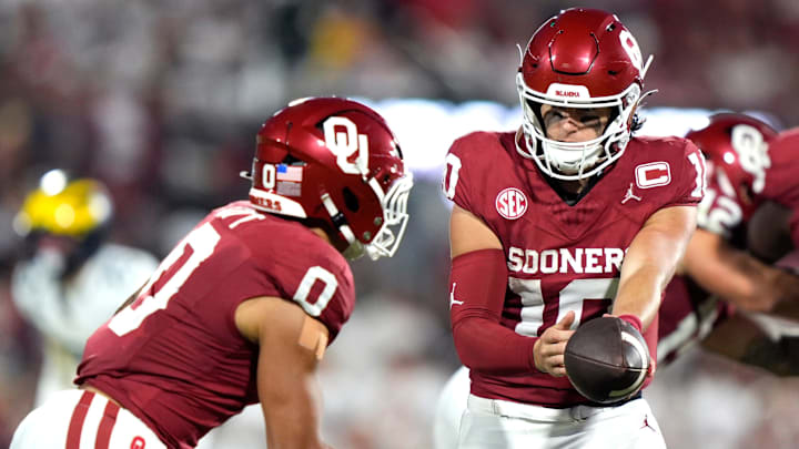 Oklahoma quarterback John Mateer hands the ball to running back Jaydn Ott. Oklahoma quarterback John Mateer hands the ball to running back Jaydn Ott.