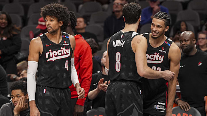 Apr 1, 2025; Atlanta, Georgia, USA; Portland Trail Blazers guard Matisse Thybulle (4) and forwards Deni Avdija (8) and  Toumani Camara (33) react late in the game against the Atlanta Hawks during the second half at State Farm Arena. Mandatory Credit: Dale Zanine-Imagn Images