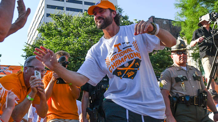 Tennessee head baseball coach Tony Vitello high-fives fans during the NCAA Baseball National Championship celebration in Downtown Knoxville on Tuesday, June 25, 2024.
