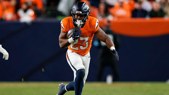 Dec 15, 2024; Denver, Colorado, USA; Denver Broncos running back Audric Estime (23) runs the ball in the fourth quarter against the Indianapolis Colts at Empower Field at Mile High. 