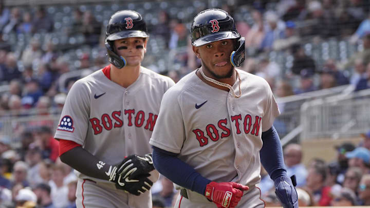 Apr 15, 2026; Minneapolis, Minnesota, USA; Boston Red Sox right fielder Roman Anthony (left) and center fielder Ceddanne Rafaela return to the dugout after scoring against the Minnesota Twins in the sixth inning on a double by shortstop Trevor Story (not pictured) at Target Field. Mandatory Credit: Bruce Kluckhohn-Imagn Images