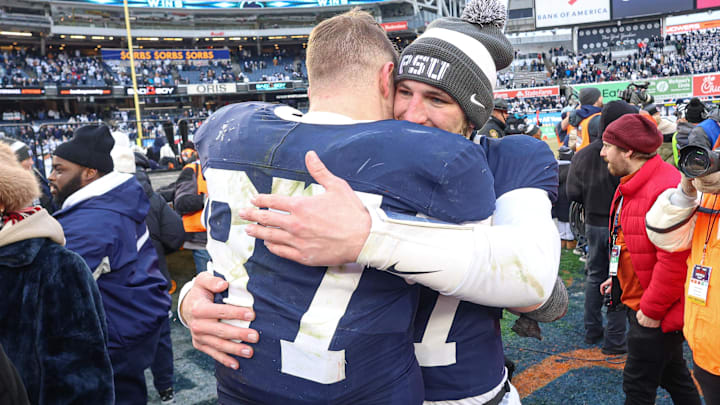 Penn State Nittany Lions quarterback Ethan Grunkemeyer (17) and tight end Andrew Rappleyea (87) hug after defeating the Clemson Tigers in the 2025 Pinstripe Bowl at Yankee Stadium. 