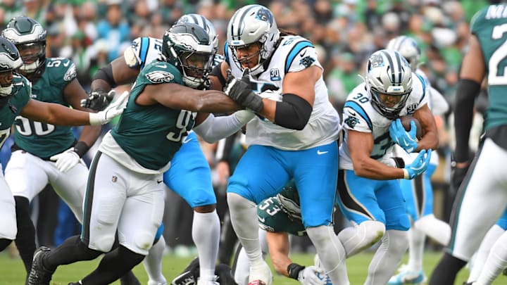 Carolina Panthers running back Chuba Hubbard (30) runs behind  guard Robert Hunt (50) as he blocks Philadelphia Eagles defensive tackle Moro Ojomo (97) at Lincoln Financial Field.