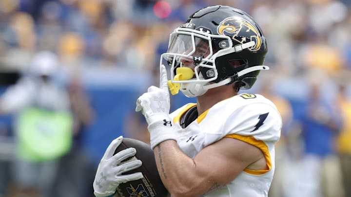 Aug 31, 2024; Pittsburgh, Pennsylvania, USA;  Kent State Golden Flashes wide receiver Luke Floriea (0) gestures to the Pittsburgh Panthers student section after scoring a touchdown during the first quarter at Acrisure Stadium. Mandatory Credit: Charles LeClaire-Imagn Images