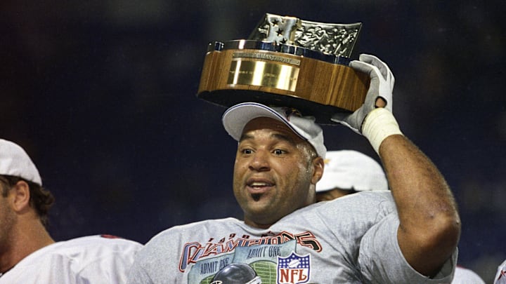 Atlanta Falcons linebacker Cornelius Bennett holds the Halas Trophy after defeating the Minnesota Vikings in the 1998 NFC Championship Game at the Metrodome. Atlanta Falcons linebacker Cornelius Bennett holds the Halas Trophy after defeating the Minnesota Vikings in the 1998 NFC Championship Game at the Metrodome.