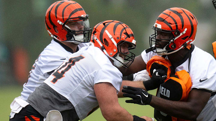 Cincinnati Bengals center Ted Karras (64) and Cincinnati Bengals guard Dylan Fairchild (63) practice blocking Cincinnati Bengals offensive tackle Jalen Rivers (74) during the Cincinnati Bengals practice in Cincinnati on Tuesday, May 27, 2025.
