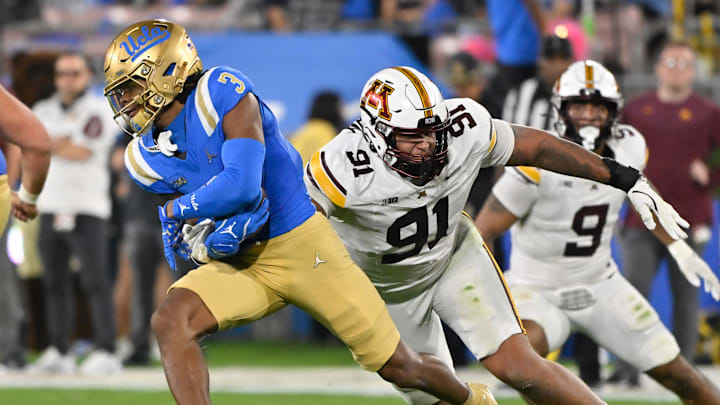 Oct 12, 2024; Pasadena, California, USA; UCLA Bruins wide receiver Kwazi Gilmer (3) runs past Minnesota Golden Gophers defensive lineman Deven Eastern (91) during the second quarter  at Rose Bowl. Mandatory Credit: Robert Hanashiro-Imagn Images