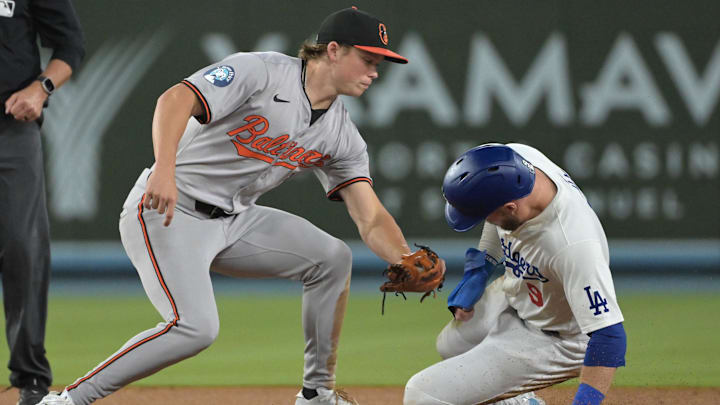 Aug 28, 2024; Los Angeles, California, USA;  Los Angeles Dodgers second baseman Gavin Lux (9) beats the tag by Baltimore Orioles second baseman Jackson Holliday (7) for a stolen base in the fifth inning at Dodger Stadium. Mandatory Credit: Jayne Kamin-Oncea-USA TODAY Sports