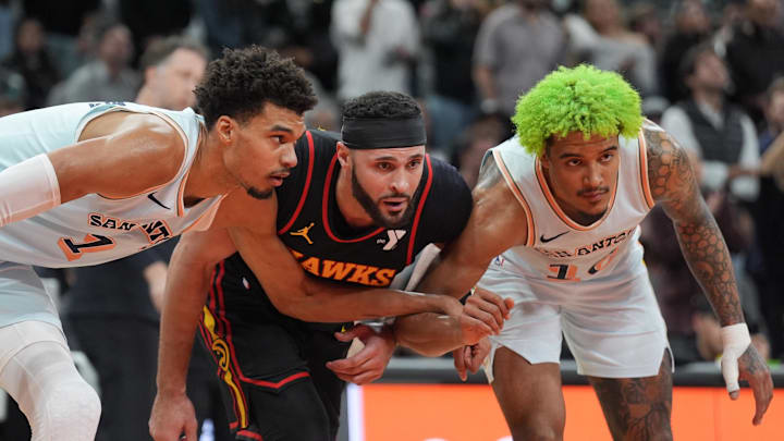 San Antonio Spurs center Victor Wembanyama (1) and forward Jeremy Sochan (10) surround Atlanta Hawks forward Larry Nance Jr. (22) in the second half at Frost Bank Center.