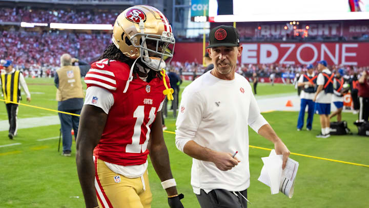 Dec 17, 2023; Glendale, Arizona, USA; San Francisco 49ers head coach Kyle Shanahan talks to wide receiver Brandon Aiyuk (11) against the Arizona Cardinals at State Farm Stadium. Mandatory Credit: Mark J. Rebilas-USA TODAY Sports