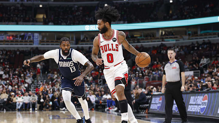 Jan 10, 2026; Chicago, Illinois, USA; Chicago Bulls guard Coby White (0) drives to the basket against Dallas Mavericks forward Naji Marshall (13) during the first half at United Center. Mandatory Credit: Kamil Krzaczynski-Imagn Images