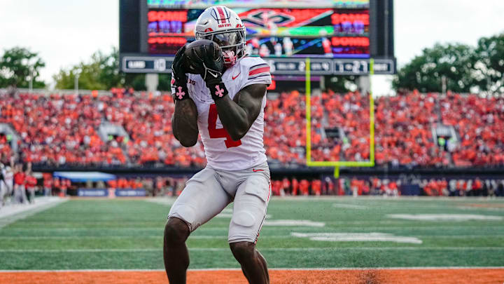 Ohio State Buckeyes wide receiver Jeremiah Smith (4) catches a touchdown pass during the second half of the NCAA football game against the Illinois Fighting Illini at Gies Memorial Stadium in Champaign on Oct. 11, 2025. Ohio State won 34-16.
