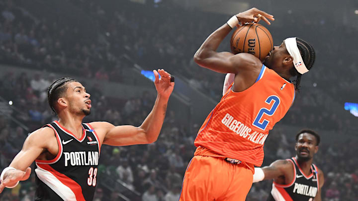 Nov 1, 2024; Portland, Oregon, USA; Oklahoma City Thunder guard Shai Gilgeous-Alexander (2) brings down an offensive rebound against Portland Trailblazers forward Toumani Camara (33) during the first quarter at Moda Center. Mandatory Credit: Brian Murphy-Imagn Images