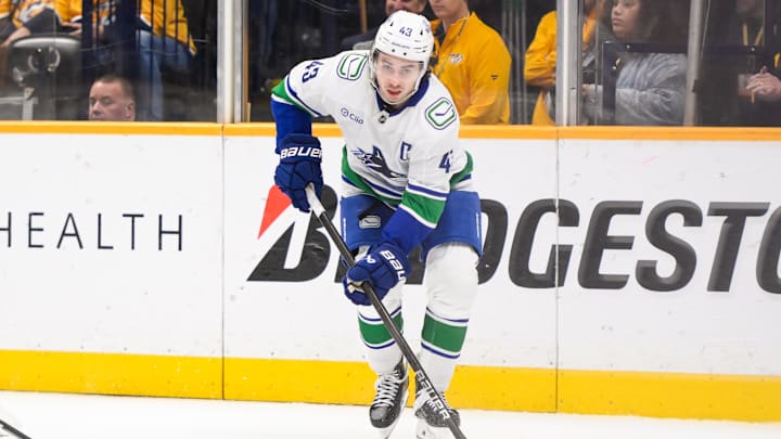 Jan 29, 2025; Nashville, Tennessee, USA;  Vancouver Canucks defenseman Quinn Hughes (43) skates behind the net against the Nashville Predators during the third period at Bridgestone Arena. Mandatory Credit: Steve Roberts-Imagn Images