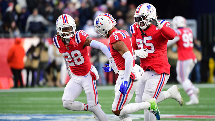 Dec 1, 2024; Foxborough, Massachusetts, USA;  New England Patriots cornerback Christian Gonzalez (0) is congratulated by defensive tackle Daniel Ekuale (95) and cornerback Alex Austin (28) after an interception during the second half against the Indianapolis Colts at Gillette Stadium. Mandatory Credit: Bob DeChiara-Imagn Images