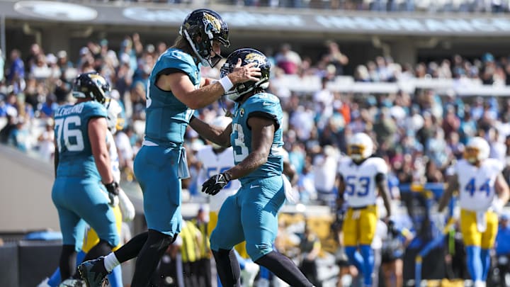 Nov 16, 2025; Jacksonville, Florida, USA; Jacksonville Jaguars running back Bhayshul Tuten (33) celebrates with quarterback Trevor Lawrence (16) after rushing for a touchdown against the Los Angeles Chargers during the first quarter at EverBank Stadium. Mandatory Credit: Nathan Ray Seebeck-Imagn Images