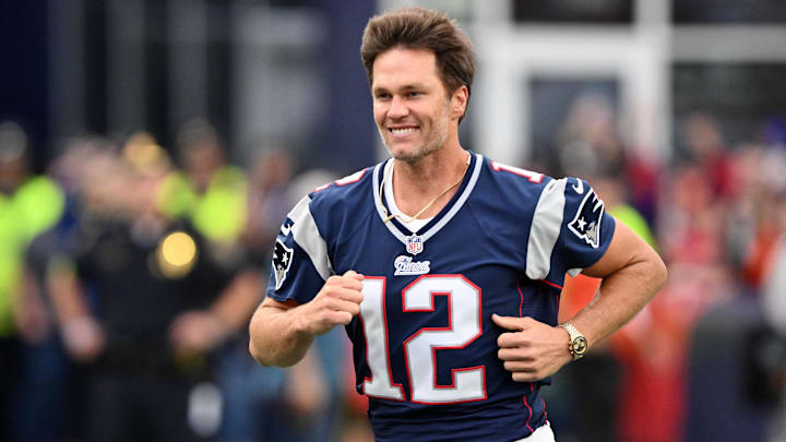 Sep 10, 2023; Foxborough, Massachusetts, USA; New England Patriots former quarterback Tom Brady runs on the field during a halftime ceremony in his honor during the game between the Philadelphia Eagles and New England Patriots at Gillette Stadium. Mandatory Credit: Brian Fluharty-Imagn Images