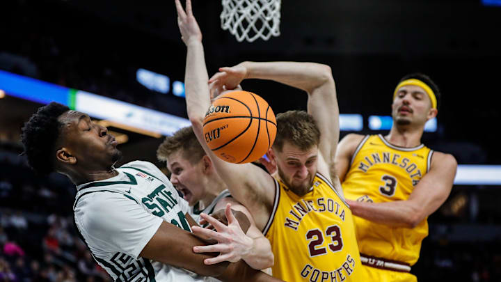 Michigan State forward Xavier Booker (34), forward Jaxon Kohler (0), Minnesota forward Parker Fox (23) and forward Dawson Garcia (3) battle for the rebound during the second half of Second Round of Big Ten tournament at Target Center in Minneapolis, Minn. on Thursday, March 14, 2024.