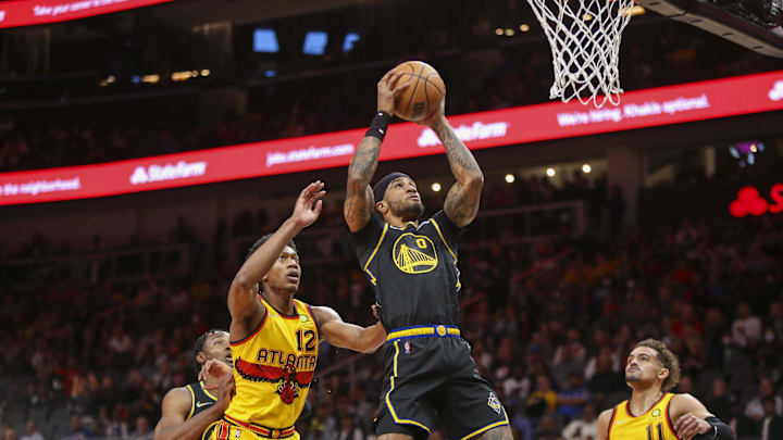 Mar 25, 2022; Atlanta, Georgia, USA; Golden State Warriors guard Gary Payton II (0) shoots past Atlanta Hawks forward De'Andre Hunter (12) and guard Trae Young (11) in the first quarter at State Farm Arena. Mandatory Credit: Brett Davis-Imagn Images Mar 25, 2022; Atlanta, Georgia, USA; Golden State Warriors guard Gary Payton II (0) shoots past Atlanta Hawks forward De'Andre Hunter (12) and guard Trae Young (11) in the first quarter at State Farm Arena. Mandatory Credit: Brett Davis-Imagn Images