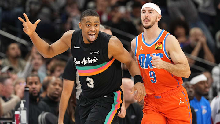 Dec 23, 2025; San Antonio, Texas, USA; San Antonio Spurs forward Keldon Johnson (3) reacts after scoring a three point basket ahead of Oklahoma City Thunder guard Alex Caruso (9) during the second half at Frost Bank Center. Mandatory Credit: Scott Wachter-Imagn Images Dec 23, 2025; San Antonio, Texas, USA; San Antonio Spurs forward Keldon Johnson (3) reacts after scoring a three point basket ahead of Oklahoma City Thunder guard Alex Caruso (9) during the second half at Frost Bank Center. Mandatory Credit: Scott Wachter-Imagn Images