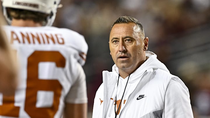 Nov 30, 2024; College Station, Texas, USA; Texas Longhorns head coach Steve Sarkisian speaks with quarterback Arch Manning (16) during warm ups against the Texas A&M Aggies at Kyle Field. Mandatory Credit: Maria Lysaker-Imagn Images 