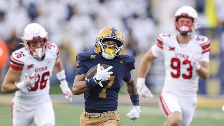 Sep 27, 2025; Morgantown, West Virginia, USA; West Virginia Mountaineers wide receiver Jarod Bowie (7) runs for extra yards during the fourth quarter against the Utah Utes at Milan Puskar Stadium. Mandatory Credit: Ben Queen-Imagn Images