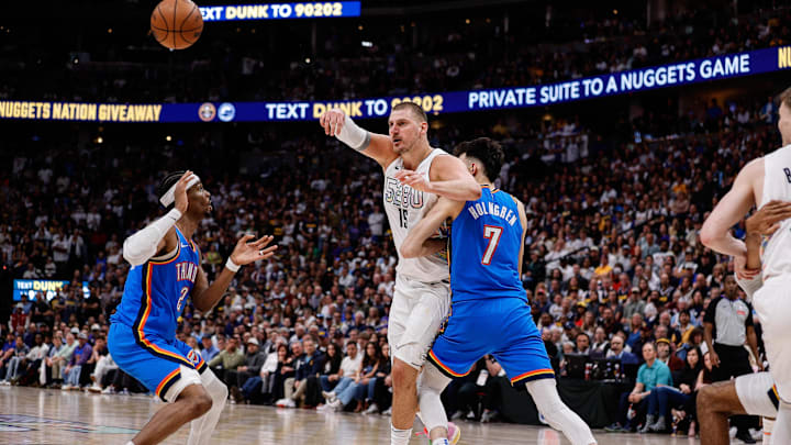 Denver Nuggets center Nikola Jokic (15) passes the ball under pressure from Oklahoma City Thunder forward Chet Holmgren (7) and guard Shai Gilgeous-Alexander (2) in the fourth quarter during game six of the second round for the 2025 NBA Playoffs at Ball Arena. Mandatory Credit: Isaiah J. Downing-Imagn Images