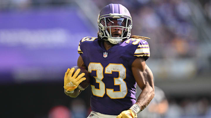 Sep 22, 2024; Minneapolis, Minnesota, USA; Minnesota Vikings running back Aaron Jones (33) runs the ball against the Houston Texans during the fourth quarter at U.S. Bank Stadium. Mandatory Credit: Jeffrey Becker-Imagn Images