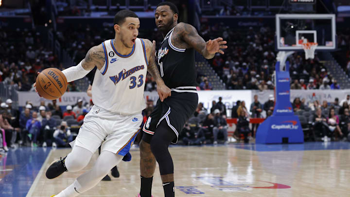 Dec 10, 2022; Washington, District of Columbia, USA; Washington Wizards forward Kyle Kuzma (33) drives to the basket as Los Angeles Clippers guard John Wall (11) defends in the first quarter at Capital One Arena. Mandatory Credit: Geoff Burke-Imagn Images