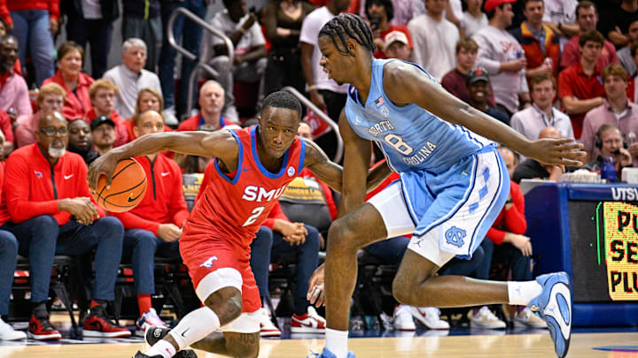 Jan 3, 2026; Dallas, Texas, USA; SMU Mustangs guard Boopie Miller (2) moves the ball past North Carolina Tar Heels forward Caleb Wilson (8) during the second half at Moody Coliseum. Mandatory Credit: Jerome Miron-Imagn Images