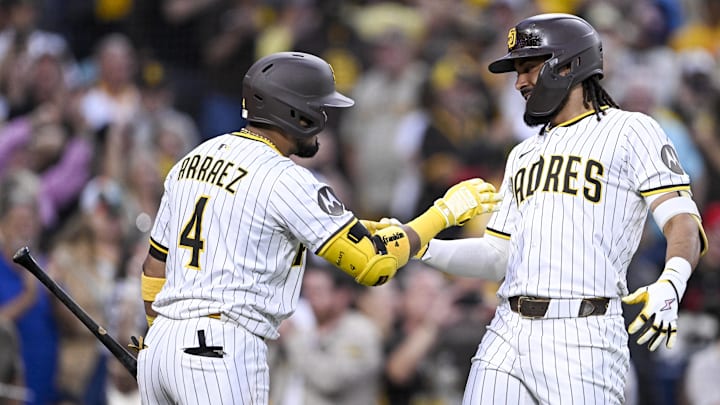 Sep 10, 2025; San Diego, California, USA; San Diego Padres right fielder Fernando Tatis Jr. (23) is congratulated by first baseman Luis Arraez (4) after hitting a solo home run during the fifth inning against the Cincinnati Reds at Petco Park. Mandatory Credit: Denis Poroy-Imagn Images Sep 10, 2025; San Diego, California, USA; San Diego Padres right fielder Fernando Tatis Jr. (23) is congratulated by first baseman Luis Arraez (4) after hitting a solo home run during the fifth inning against the Cincinnati Reds at Petco Park. Mandatory Credit: Denis Poroy-Imagn Images