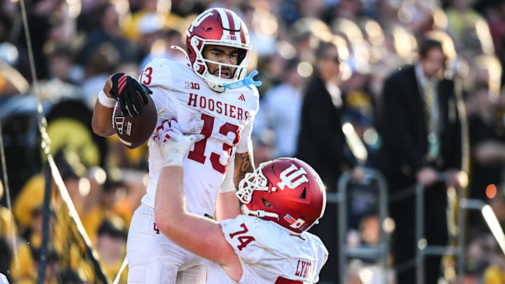 Sep 27, 2025; Iowa City, Iowa, USA; Indiana Hoosiers wide receiver Elijah Sarratt (13) reacts with offensive lineman Bray Lynch (74) after completing a 49-yard touchdown reception late during the fourth quarter against the Iowa Hawkeyes at Kinnick Stadium. Mandatory Credit: Jeffrey Becker-Imagn Images