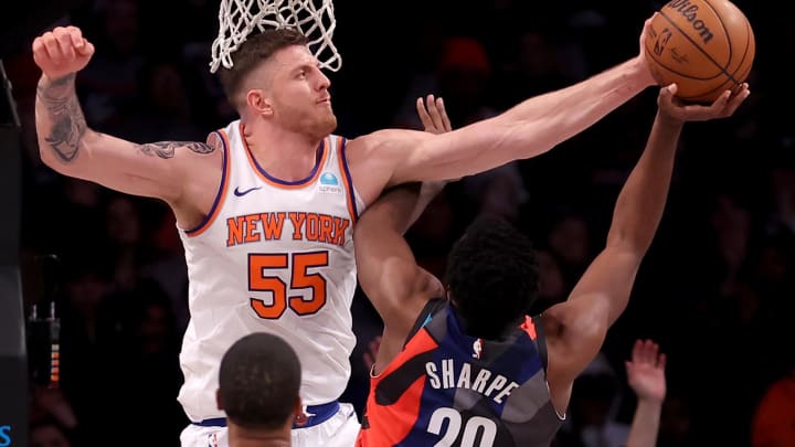 Dec 20, 2023; Brooklyn, New York, USA; New York Knicks center Isaiah Hartenstein (55) blocks a shot by Brooklyn Nets center Day'Ron Sharpe (20) during the second quarter at Barclays Center. Mandatory Credit: Brad Penner-USA TODAY Sports