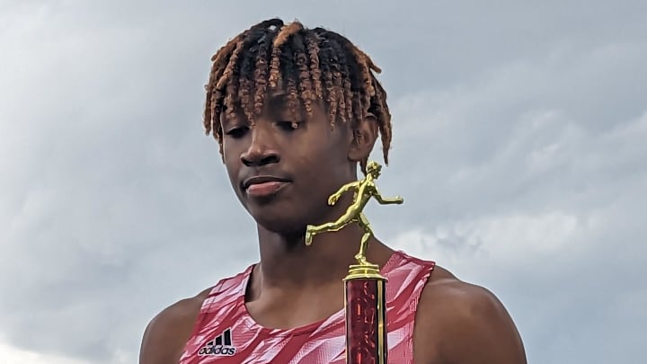 Florida High's Micahi Danzy holds the championship trophy from the boys 400-meter run at the Bob Hayes Invitational Trophy on March 18, 2023. [Clayton Freeman/Florida Times-Union]

Pxl 20230318 211918691