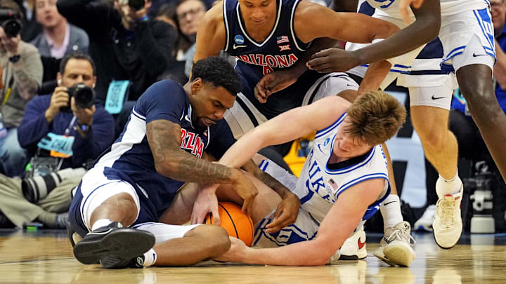 Mar 27, 2025; Newark, NJ, USA; Duke Blue Devils guard Kon Knueppel (7) and Arizona Wildcats guard KJ Lewis (5) go for the ball during the second half during an East Regional semifinal of the 2025 NCAA tournament at Prudential Center. Mandatory Credit: Robert Deutsch-Imagn Images