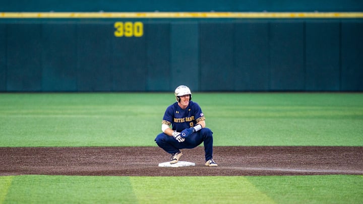 Notre Dame's Jack Brannigan (9) stays on second base as umps review a call during the first round of