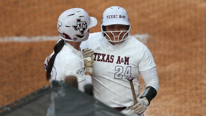 Texas A&M infielder Mya Perez (24) reacts to her run with Texas A&M infielder Koko Wooley (3) during a game against Texas at Jack Turner Stadium.