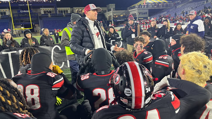Quince Orchard head football coach John Kelley addresses his team after its victory in the 2024 MPSSAA 4A state championship game.