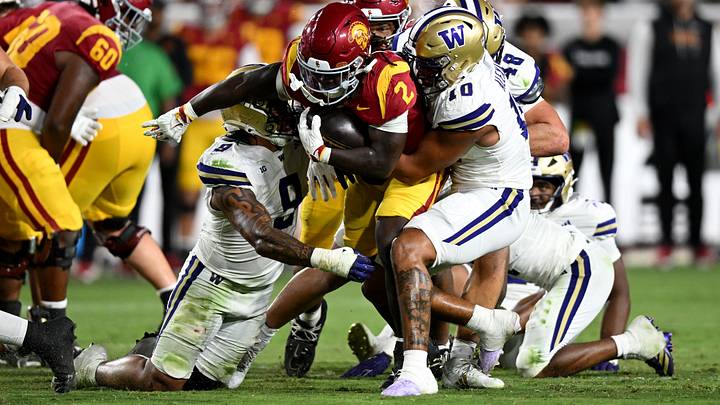 UW linebackers Jacob Manu (9) and Xe'ree Alexander (10) bookend tackle USC running back Waymond Jordan (2). UW linebackers Jacob Manu (9) and Xe'ree Alexander (10) bookend tackle USC running back Waymond Jordan (2).