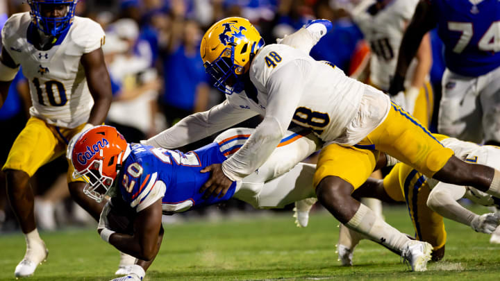 Sep 9, 2023; Gainesville, Florida, USA; Florida Gators running back Treyaun Webb (20) stretches for a first down tackled by McNeese State Cowboys linebacker Micah Davey (48) during the second half at Ben Hill Griffin Stadium. Mandatory Credit: Matt Pendleton-USA TODAY Sports
