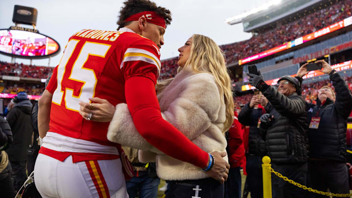 Kansas City Chiefs quarterback Patrick Mahomes (15) and wife Brittany Mahomes kiss before the AFC Championship game against the Buffalo Bills at GEHA Field at Arrowhead Stadium.