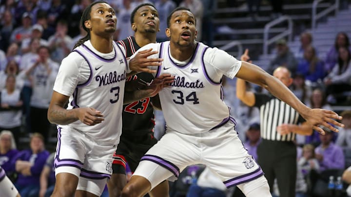 Jan 11, 2025; Manhattan, Kansas, USA; Houston Cougars guard Terrance Arceneaux (23) is blocked out by Kansas State Wildcats center Ugonna Onyenso (34) and guard C.J. Jones (3) during the second half at Bramlage Coliseum. Mandatory Credit: Scott Sewell-Imagn Images