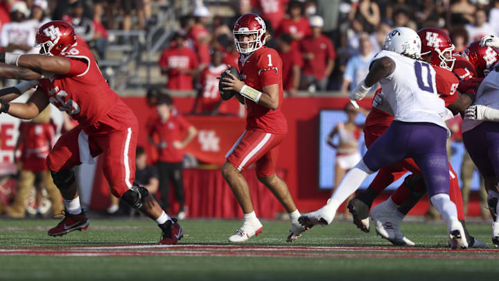 Nov 22, 2025; Houston, Texas, USA; Houston Cougars quarterback Conner Weigman (1) looks for an open receiver during the first quarter against the TCU Horned Frogs at TDECU Stadium. Nov 22, 2025; Houston, Texas, USA; Houston Cougars quarterback Conner Weigman (1) looks for an open receiver during the first quarter against the TCU Horned Frogs at TDECU Stadium.
