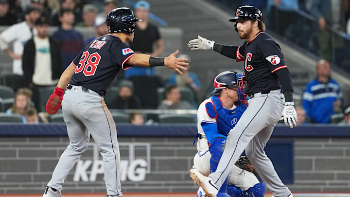 May 3, 2025; Toronto, Ontario, CAN; Cleveland Guardians second baseman Daniel Schneemann, right, celebrates his grand slam with left fielder Steven Kwan (38) against the Toronto Blue Jays at during the ninth inning at Rogers Centre. Mandatory Credit: Nick Turchiaro-Imagn Images
