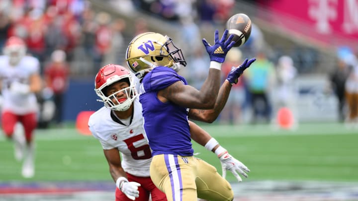 Sep 14, 2024; Seattle, Washington, USA; Washington Huskies wide receiver Giles Jackson (5) catches a pass over Washington State Cougars defensive back Tyson Durant (5) during the second half at Lumen Field. Mandatory Credit: Steven Bisig-Imagn Images