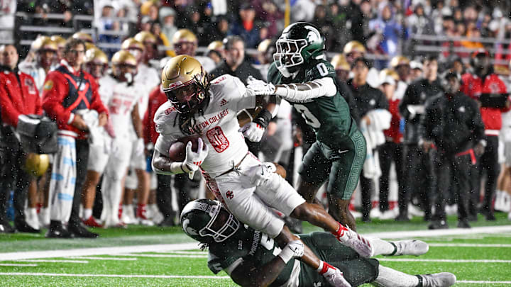 Sep 21, 2024; Chestnut Hill, Massachusetts, USA; Boston College Eagles running back Treshaun Ward (0) is tackled by Michigan State Spartans defensive back Charles Brantley (0) and linebacker Jordan Hall (5) during the first half at Alumni Stadium. Mandatory Credit: Eric Canha-Imagn Images