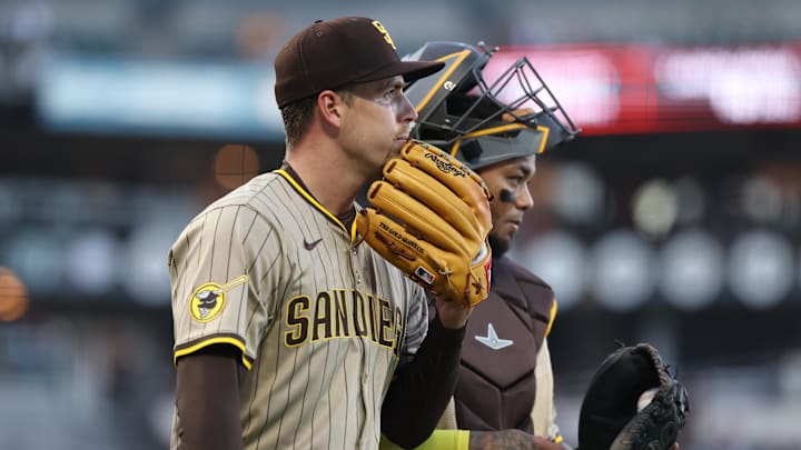 Jun 3, 2025; San Francisco, California, USA; San Diego Padres starting pitcher Ryan Bergert (38) and catcher Martin Maldonado (15) after a play at the plate against the San Francisco Giants during the third inning at Oracle Park. Mandatory Credit: Kelley L Cox-Imagn Images