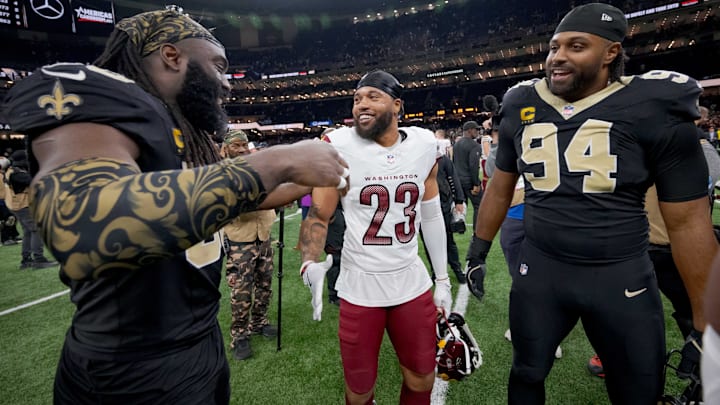 Dec. 15, 2024; Saints LB Demario Davis and DE Cam Jordan (94) greet former teammate Washington cornerback Marshon Lattimore (23)