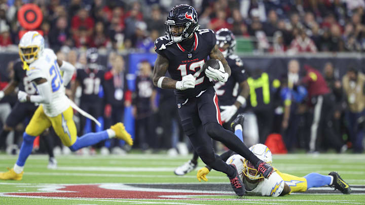 Jan 11, 2025; Houston, Texas, USA; Houston Texans wide receiver Nico Collins (12) runs with the ball after a reception during the game against the Los Angeles Chargers in an AFC wild card game at NRG Stadium. Mandatory Credit: Troy Taormina-Imagn Images