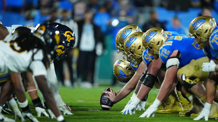 Nov 25, 2023; Pasadena, California, USA; Helmets at the line of scrimmage as UCLA Bruins long snapper Beau Gardner (60) snaps the ball against the California Golden Bears at the Rose Bowl. Mandatory Credit: Kirby Lee-Imagn Images Nov 25, 2023; Pasadena, California, USA; Helmets at the line of scrimmage as UCLA Bruins long snapper Beau Gardner (60) snaps the ball against the California Golden Bears at the Rose Bowl. Mandatory Credit: Kirby Lee-Imagn Images